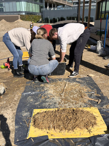 Greenbuildinglab Team mixing Earth with Grass